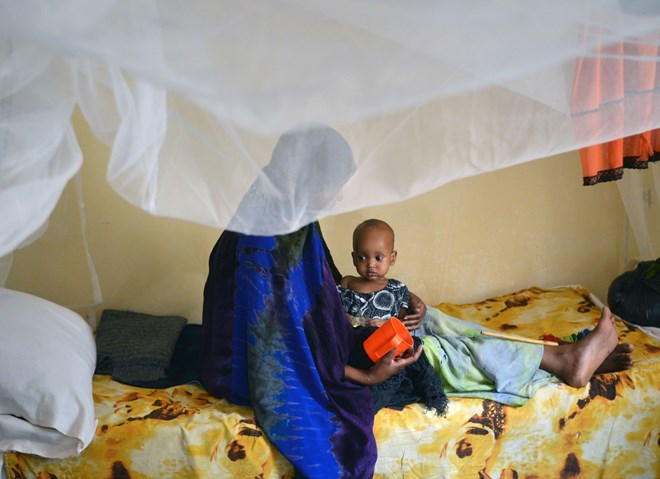 A malnourished child is fed a special formula by her mother at a regional hospital in Somalia. (TONY KARUMBA/Agence France-Presse via Getty Images)